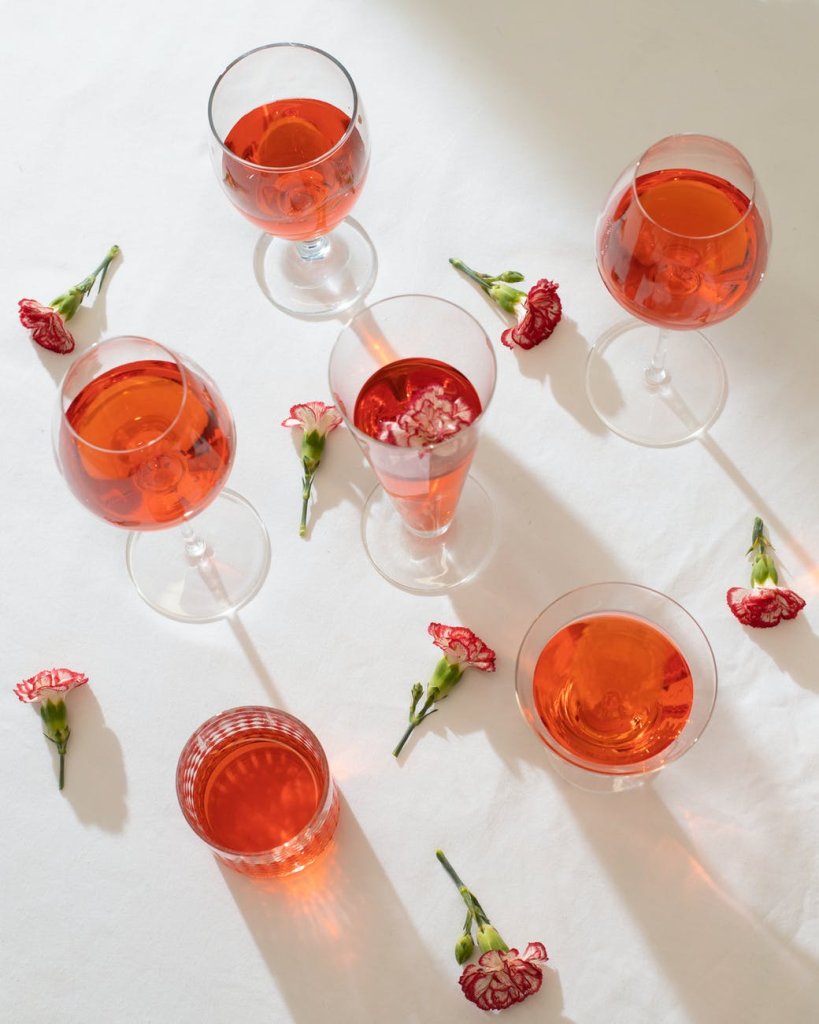 glasses and flowers on white surface